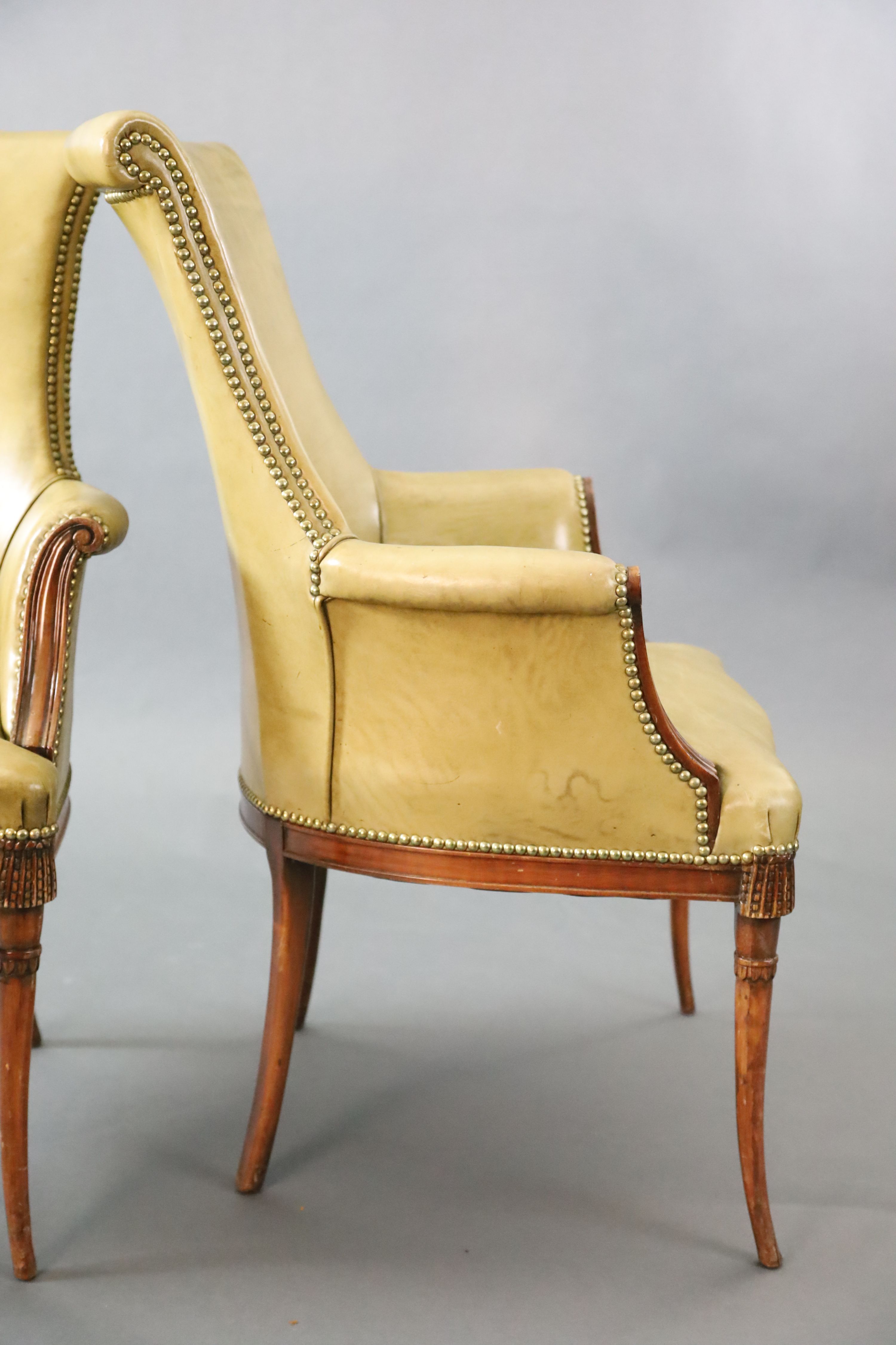 A pair of Regency style leather and mahogany library chairs, W.2ft 3in. D.2ft 3in. H.3ft 2in.